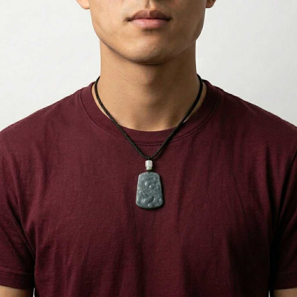 Hand-carved green natural jade dragon pendant necklace on black cord.